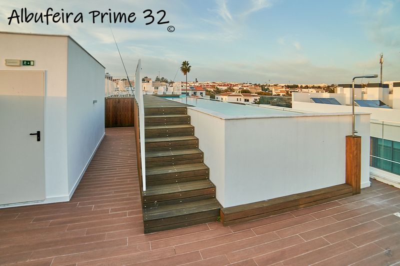 Steps up to the rooftop communal swimming pool