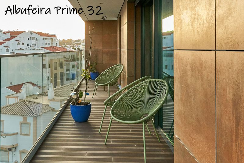 Long balcony with chairs and views over the rooftops