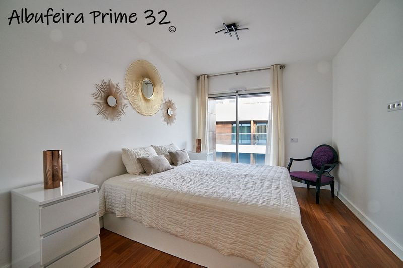 Master bedroom with double bed and doors to the balcony